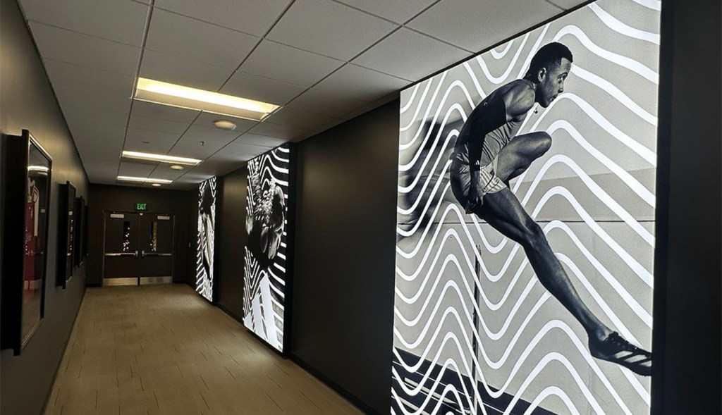 Hallway wall decorated with murals of athletes