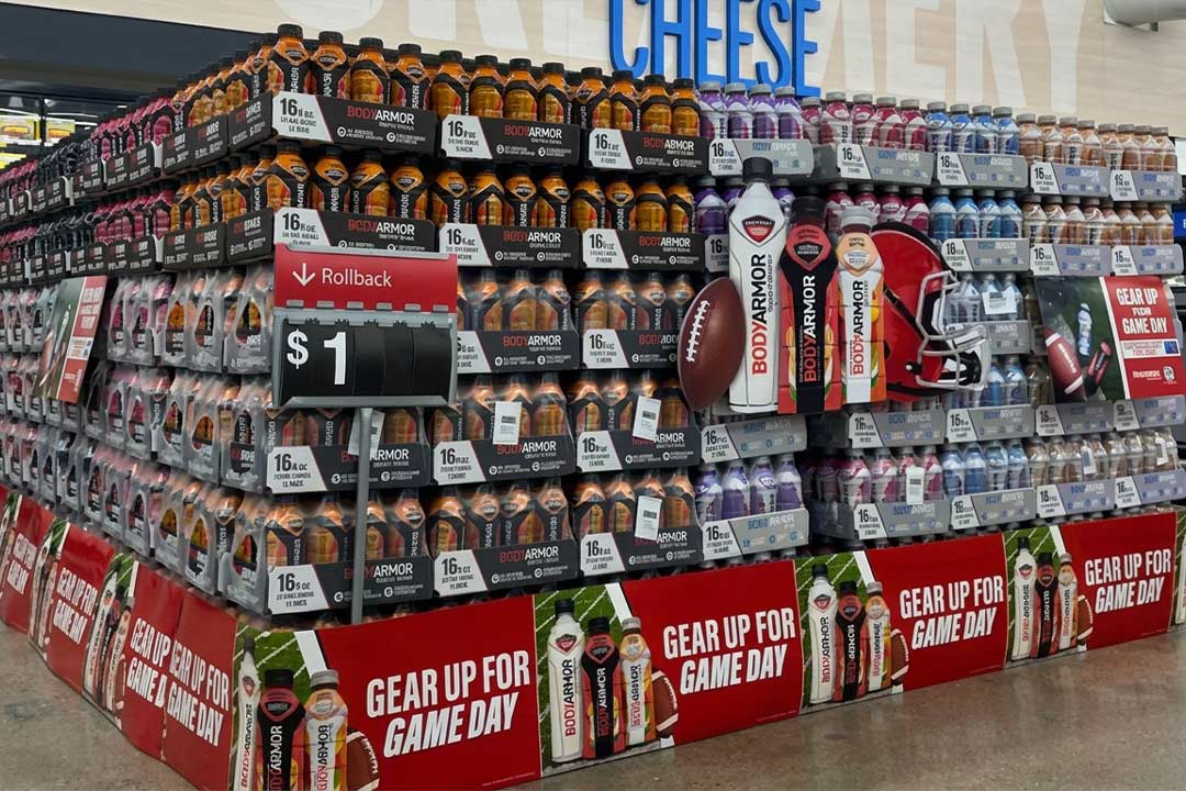 BODYARMOR sports drink display with football-themed Game Day signage and rollback pricing.
